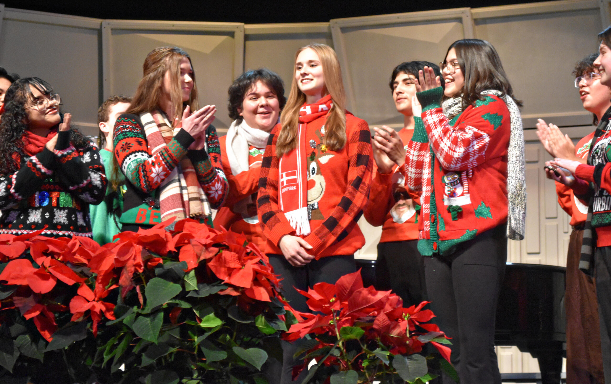 The choir applauds sophomore Gwen Nika, who was selected for the Illinois Music Education Association's district performance this fall. (Photo by Karidja Monjolo)