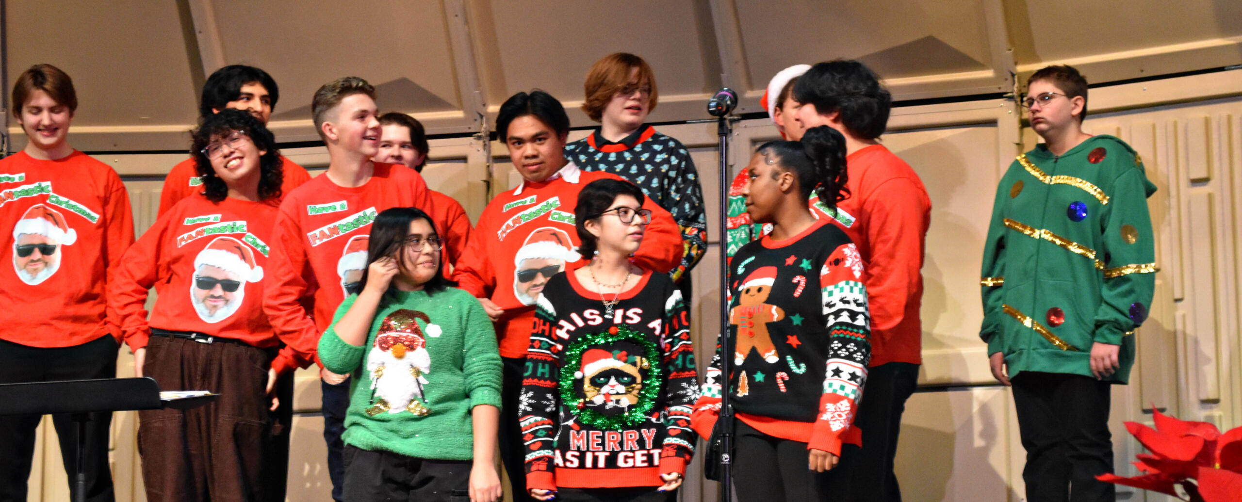 Choir members show off their "FANtastic Christmas" sweaters. (Photo by Karidja Monjolo)